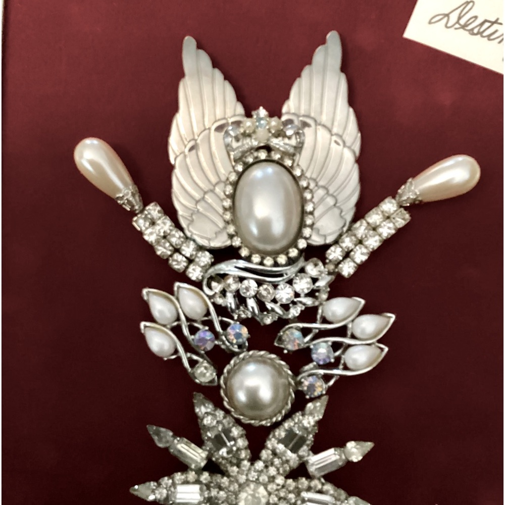 Angel Destiny was created out of broken down jewelry on a red velvet